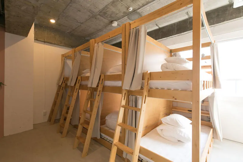 A row of bunk beds with curtains
